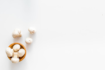 Mushroom champignons. Fresh raw whole champignons on white background top view copy space