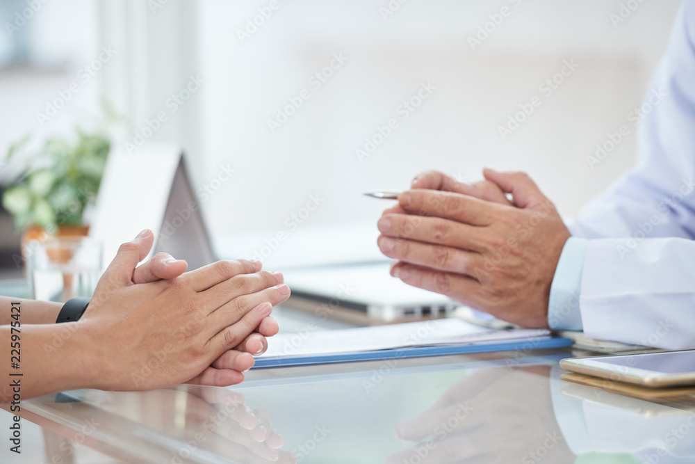 Wall mural Hands of doctor and patient during conversation