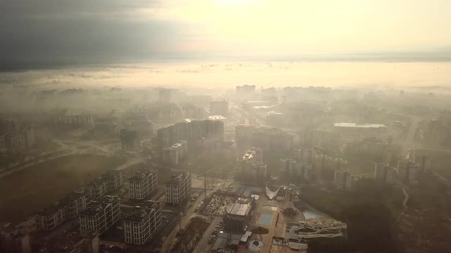 Flying over a concrete living apartment area in east Europa with many birds flying around the drone