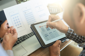 Team of UX designers discussing color palette for mobile application