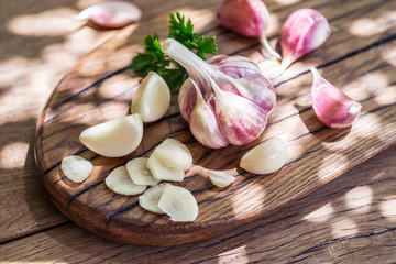 Garlic bulb and garlic cloves  on the wooden table.