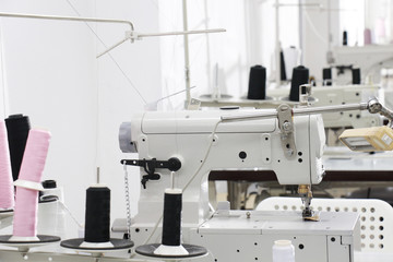 a row of sewing machine in tailor workplace
