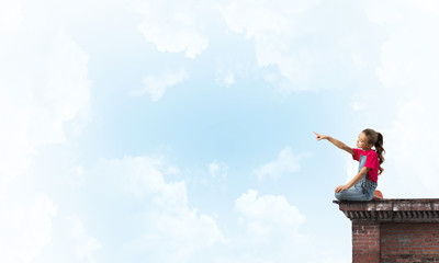 Concept of careless happy childhood with girl showing touch gesture