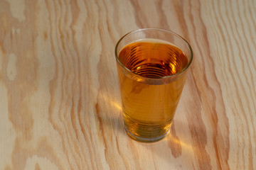 Glass of apple juice on a wooden table