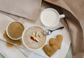 Healthy breakfast. Sesame dry cookies in the form of heart porridge of amaranth with apples  and yogurt..