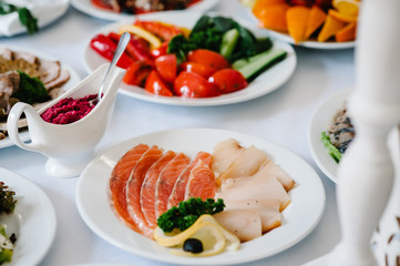 Dish. Red caviar and fish. Tuna. White plate on white table. Food. Fish eggs olives. Holiday food. Wedding day.