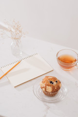 Breakfast with fresh homemade delicious muffins and tea.