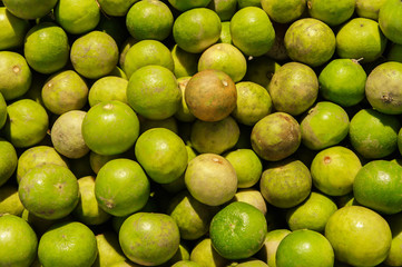 Stack of many green lime in the market. For food, fruit, kitchen, texture, background and vegetables.
