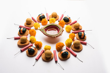 Rangoli or design made using Indian snacks/sweet and firecrackers or patakhe for Diwali festival 