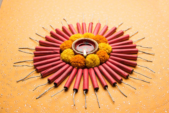 Diwali Firecrackers along with Clay oil lamp or Diya arranged over white background to create a beautiful rangoli or design