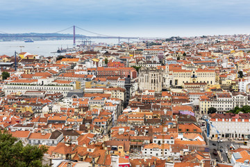 Lisbon city skyline viewed from the castle. The 25 de Abril Bridge over the river Tagus can be seen in the distance