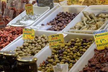 traditional olives lined up in boxes  sold in the food market in italy