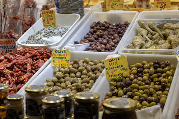 traditional olives lined up in boxes  sold in the food market in italy
