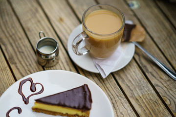 Slice of cake and cup of English tea whit milk