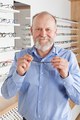 Elderly man in optics store