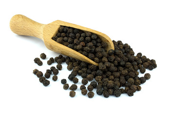 Black pepper on wooden scoop isolated on white background