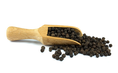 Black pepper on wooden scoop isolated on white background