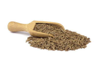 Cumin seed on wooden scoop isolated on white background