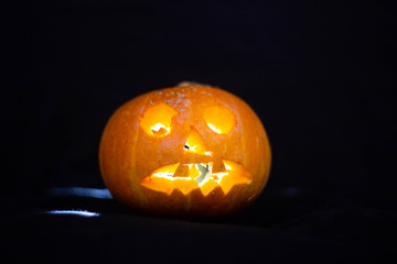 glowing inside pumpkin on a black background