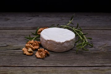 Fresh bread, Camembert cheese and cowberry jam served on a vintage styled dark wooden table. Menu design horizontal