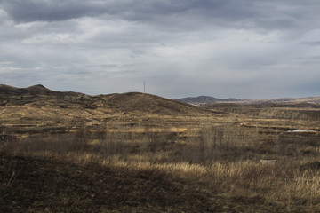 Steppe landscape. Hills and grey sky.