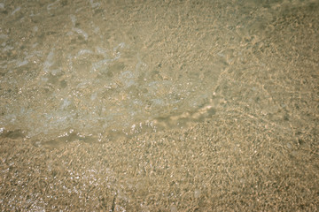 droped sungrass and small waves lapped the beach
