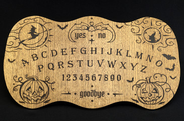 Ouija Board, yellow on a black background