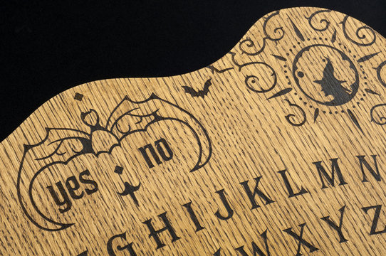 Ouija Board, yellow on a black background