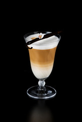 cup cappuccino latte coffee with vanilla pods on a black background