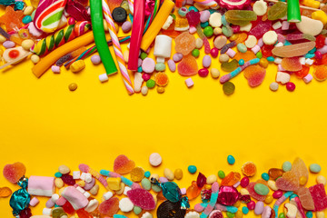 colored candies on yellow background