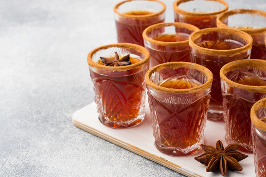 Mulled wine cider in small stacks with cinnamon and anise. The concept of the cocktail bar.