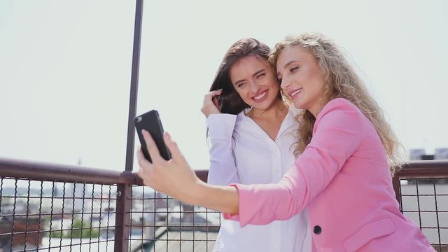 Women Making Photo On Mobile Phone Outdoors