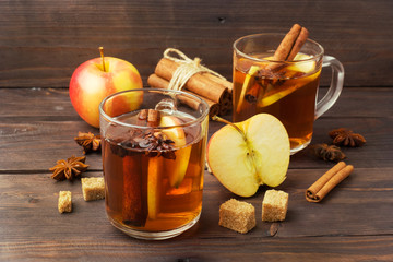 Mulled wine cider in glass mugs with cinnamon, anise and apples. The concept of the cocktail bar.