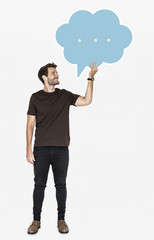 Cheerful man holding a blank speech bubble symbol