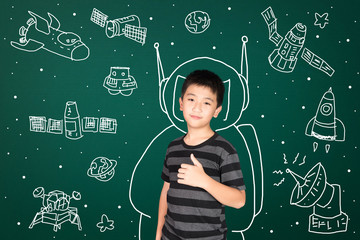 Asian kid with his imagination about science and space adventure, hand drawn on the green chalkboard, education back to school and discovery concept.