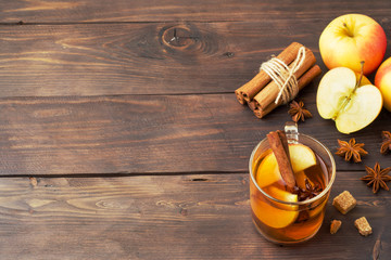Mulled wine cider in glass mugs with cinnamon, anise and apples. The concept of the cocktail bar. Copy space