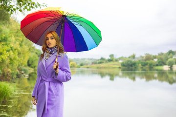 Plus size nice American or European appearance woman with umbrella, enjoy the life, walks outdoor. Life of people happy nice natural beauty woman. Concept of  women lifestyle, new age beauty 