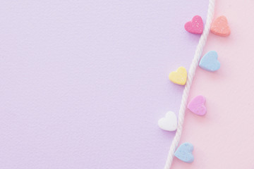 Sweet mini hearts in colorful on white rope in pastel background