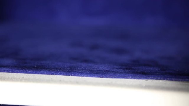 Safe inside. View of internal section of the safe. The cell is covered with special velvety soft material. Color of material blue. Camera is moving on material