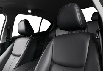 Fototapeta premium Modern luxury car black leather interior. Part of leather car seat details with stitching. Interior of prestige modern car. Comfortable perforated leather seat. Black perforated leather. Car detailing