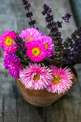 Pink  flowers of Aster. Bouquet of flowers. Violet basil. Bouquet of Asters on wooden background.	