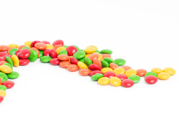 Creative arrangement of colorful candies and sweets on white background