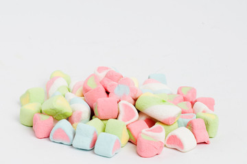 Creative arrangement of colorful candies and sweets on white background