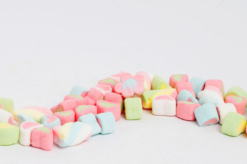 Creative arrangement of colorful candies and sweets on white background