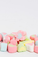 Creative arrangement of colorful candies and sweets on white background