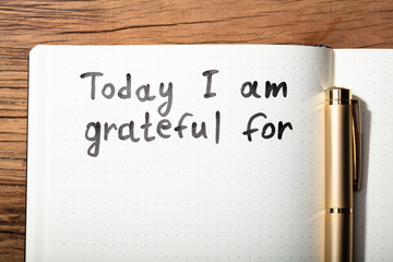 Gratitude Word With Pen On Notebook