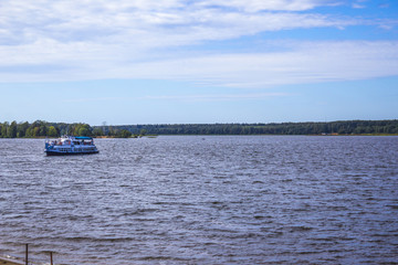 Sunny day. The Volga River near Konakovo. Pleasure boat in the middle of the river.Tver Region,Russia.Background for the site about travel, vacation.