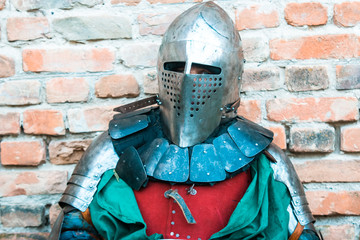 Medieval knight in armor. Green clothes.