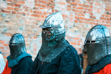 Three medieval knights in armor.