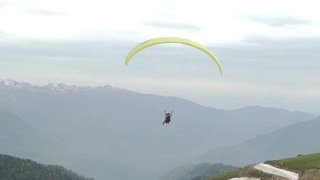 Paragliding with two people. Flying over mountains